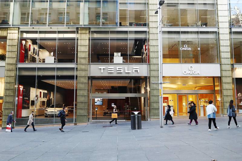 Pedestrians walk past a Tesla Inc. showroom and an Omega SA store at Martin Place in Sydney, Australia, on Wednesday, June 3, 2020. Australia’s economy contracted in the first three months of the year, setting up an end to a nearly 29-year run without a recession as an even deeper slowdown looms for the current quarter. Photographer: Brendon Thorne/Bloomberg