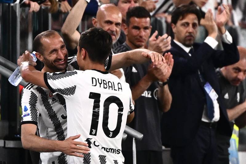 Juventus’ forward Paulo Dybala hugs teammate Giorgio Chiellini after being substituted with 12 minutes left against Lazio. AFP