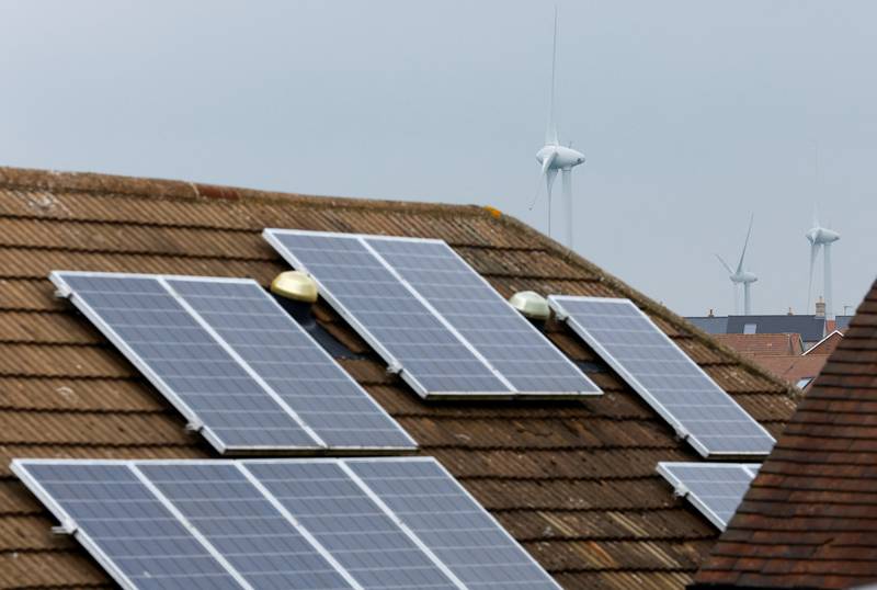 Solar energy panels and wind turbines in Burton Latimer, England, as Europeans try to cut energy use. Reuters