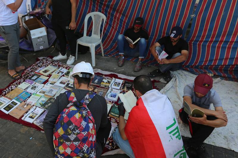 Iraqi protesters read books at Baghdad's Tahrir Square as the Iraqi capital braces for another day of anti-government demonstrations. AFP