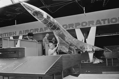 A worker cleans a transparent model of the supersonic passenger airliner Concorde at a British Aircraft Corporation exhibit at Farnborough Airshow in 1966.