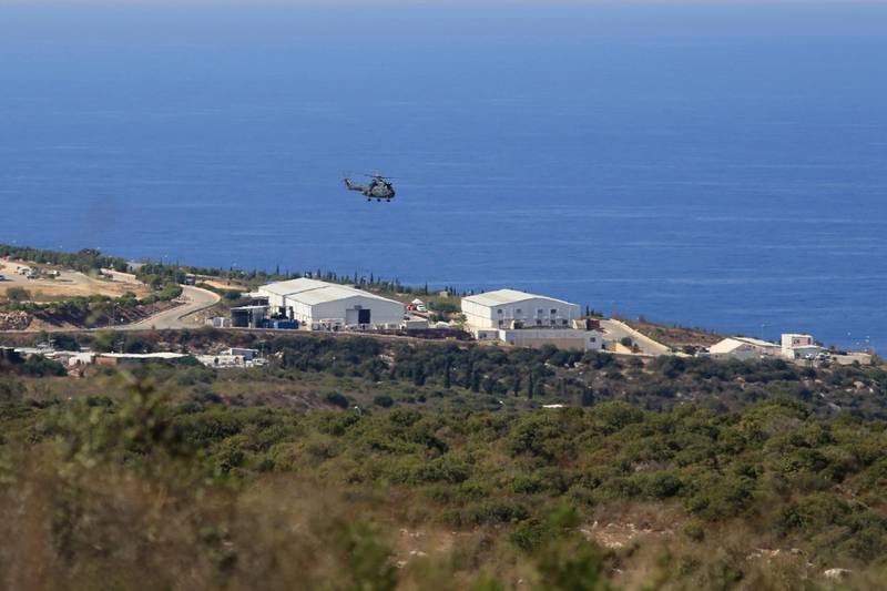 FILE - In this Oct. 14, 2020 file photo, a helicopter flies over a base of the U.N. peacekeeping force, in the southern town of Naqoura, Lebanon. On Wednesday, Oct. 28, 2020, Lebanon and Israel held a second round of U.S.-mediated talks over their disputed maritime border and agreed on a third meeting. The U.S.-mediated talks are being held in a tent at the U.N. post along the border known as Ras Naqoura, on the edge of the Lebanese border town of Naqoura. (AP Photo/Bilal Hussein, File)