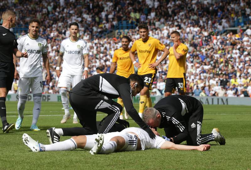 Leeds United's Rasmus Kristensen lies injured after a collision with Wolverhampton Wanderers goalkeeper Jose Sa. PA