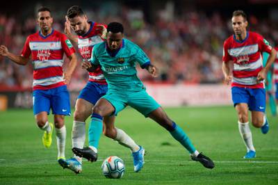 Granada's Spanish midfielder Antonio Puertas vies with Barcelona's Guinea-Bissau forward Ansu Fati. EPA
