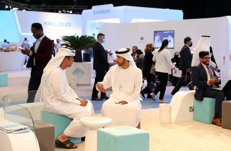 Delegates chat at the World Government Summit at Dubai Exhibition Centre. Pawan Singh / The National