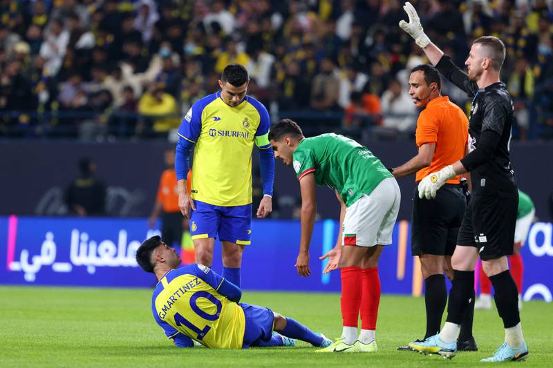 All Nassr's Portuguese forward Cristiano Ronaldo checks on teammate Pity Martinez during the game. AFP