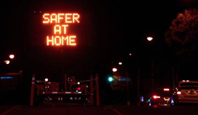 A sign reminds motorists it's "Safer At Home" in Los Angeles, California. AFP