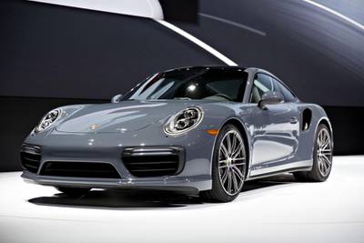 The Porsche AG 911 Turbo vehicle sits on stage during the debut at the 2016 North American International Auto Show (NAIAS) in Detroit, Michigan, U.S., on Monday, Jan. 11, 2016. Last year's auto show featured 55 vehicle introductions, a majority of which were worldwide debuts, and was attended by over 5,000 journalists from 60 countries. Photographer: Daniel Acker/Bloomberg