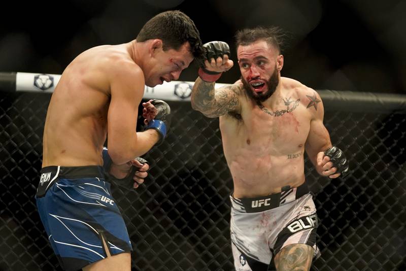 Shane Burgos, right, throws a punch against Billy Quarantillo during a featherweight bout. AP Photo