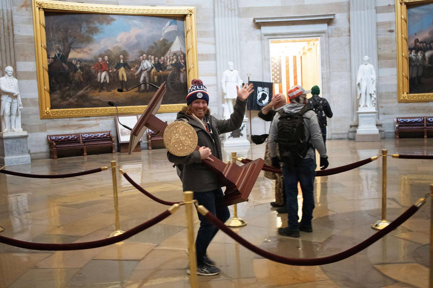 WASHINGTON, DC - JANUARY 06: A pro-Trump protester carries the lectern of U.S. Speaker of the House Nancy Pelosi through the Roturnda of the U.S. Capitol Building after a pro-Trump mob stormed the building on January 06, 2021 in Washington, DC. Congress held a joint session today to ratify President-elect Joe Biden's 306-232 Electoral College win over President Donald Trump. A group of Republican senators said they would reject the Electoral College votes of several states unless Congress appointed a commission to audit the election results.   Win McNamee/Getty Images/AFP
== FOR NEWSPAPERS, INTERNET, TELCOS & TELEVISION USE ONLY ==
