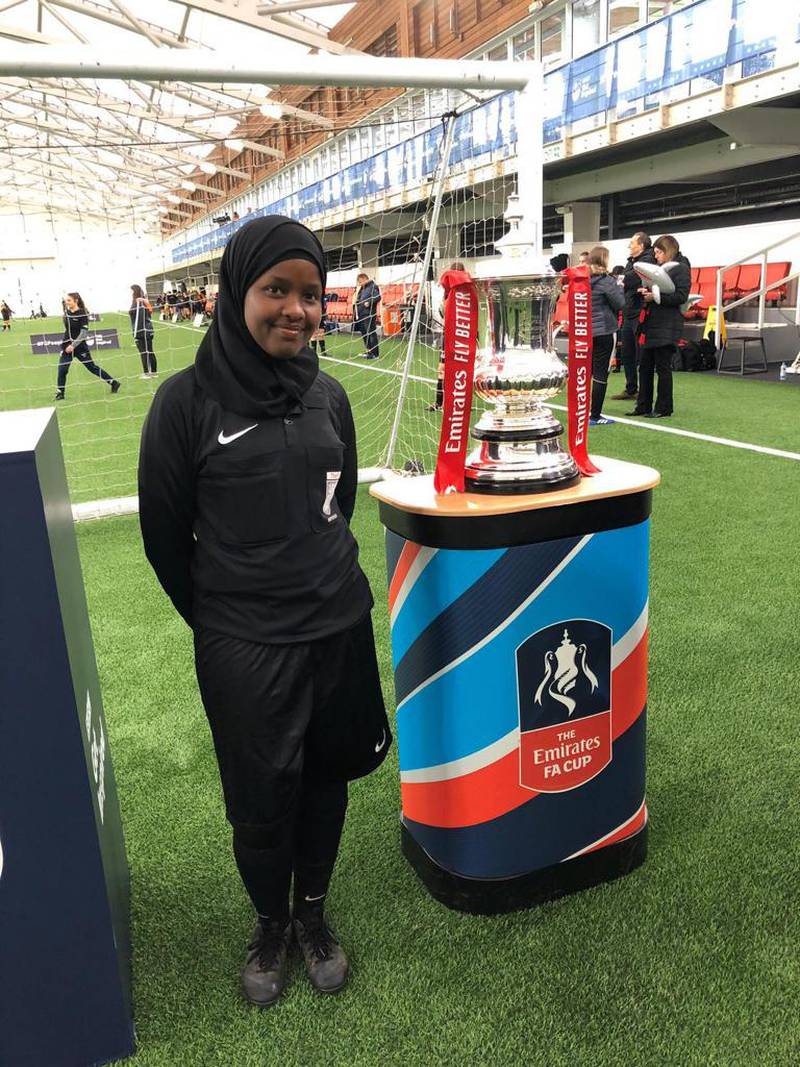 JJ, next to the Emirates FA Cup, says: 'With the obsession I have with football, you would think that someone encouraged me or a teacher influenced me. But, no, I just fell in love with it out of nowhere' Photo: Jawahir Roble