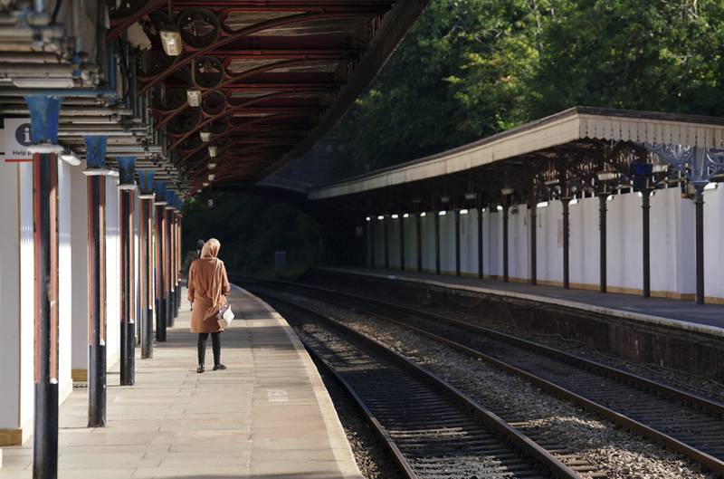A passenger waits at Great Malvern station in Worcestershire, central England. AP