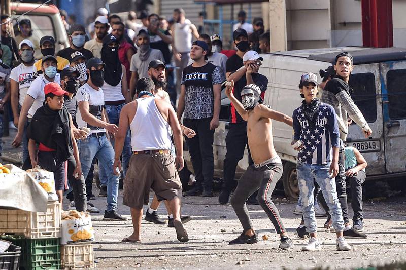 Lebanese anti-government protesters throw rocks at soldiers amid clashes in the Bab al-Tabbaneh neighbourhood in the northern port city of Tripoli on the third consecutive day of demonstrations against deepening economic crisis.  AFP