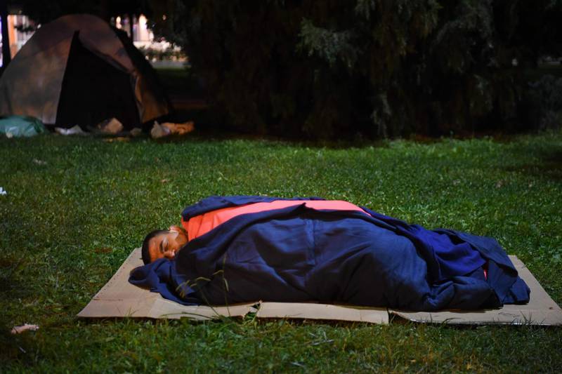 A man sleeps in a sleeping bag outside after a powerful earthquake struck Turkey's western coast and parts of Greece, in Izmir.  AFP
