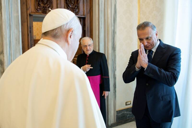 Mr Al Kadhimi greets the Pope on arrival..
