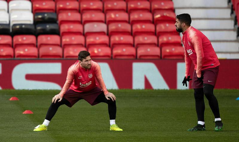 Barcelona's Lionel Messi, left, and Luis Suarez during the training session at Old Trafford, Manchester. AP