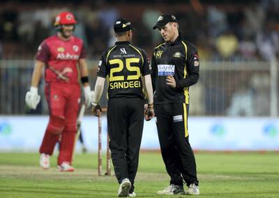 Sharjah, United Arab Emirates - November 22, 2018: Knights' Sandeep Lamichhane talks with captain Eoin Morgan during the game between Kerala Knights and Sindhis in the T10 league. Thursday the 22nd of November 2018 at Sharjah cricket stadium, Sharjah. Chris Whiteoak / The National