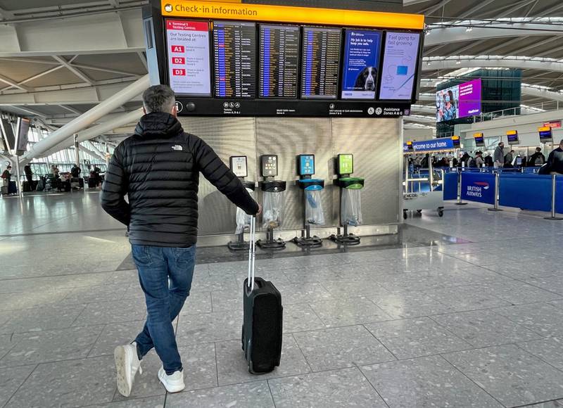 Passengers at Heathrow Airport Terminal 5 in London. About 2.8 million passengers travelled through the UK hub last month, 15 per cent below its forecast. PA
