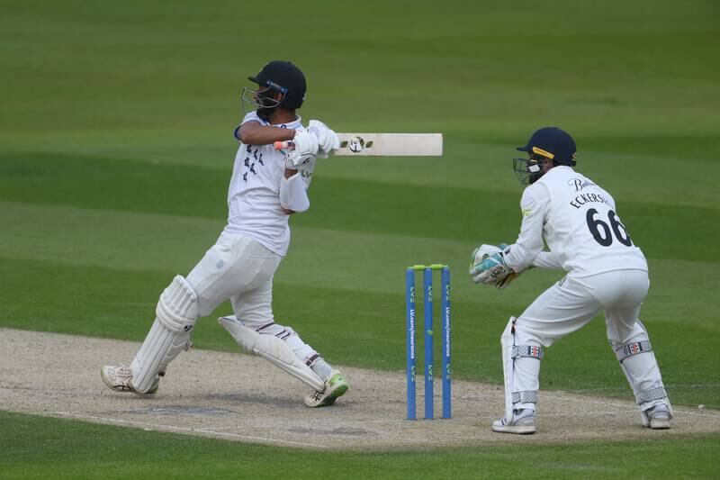 Cheteshwar Pujara of Sussex hits a boundary to bring up his half century. Getty