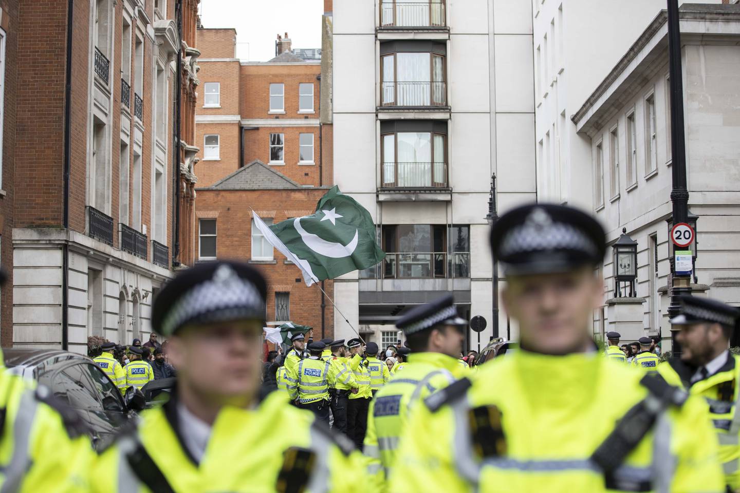 Police officers watch as a protest is staged in front of the house of Nawaz Sharif in London. Getty Images