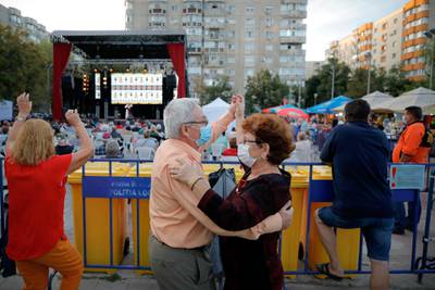 People attends a folk music concert in a park in Bucharest, Romania. AP Photo