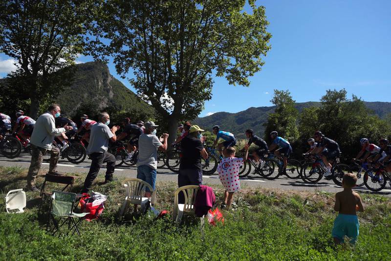 Spectators applaud the riders during Stage 4. PA