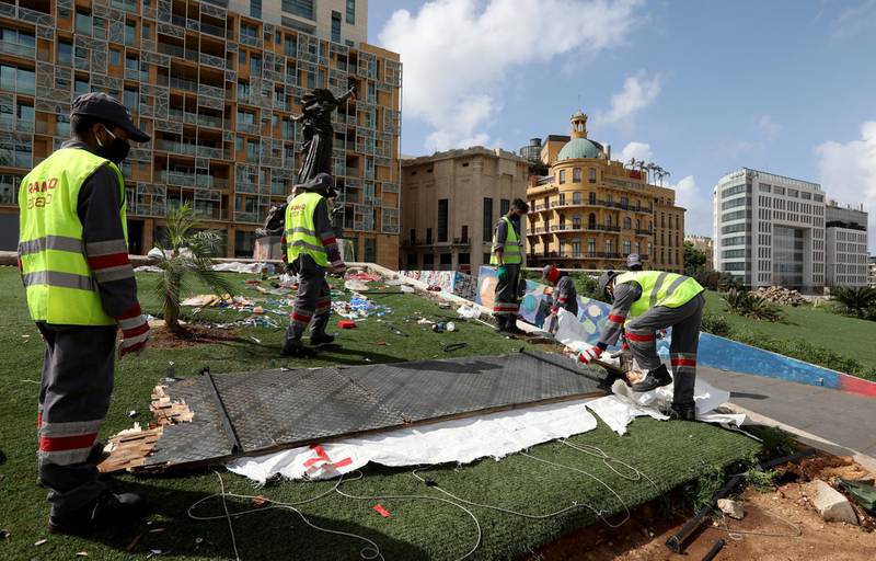 Workers clean the area around Martyrs' Square after Lebanese security forces cleared away a protest camp and reopened roads blocked by demonstrators since protests against the governing elite started in October, in Beirut, Lebanon March 28, 2020. REUTERS/Mohamed Azakir