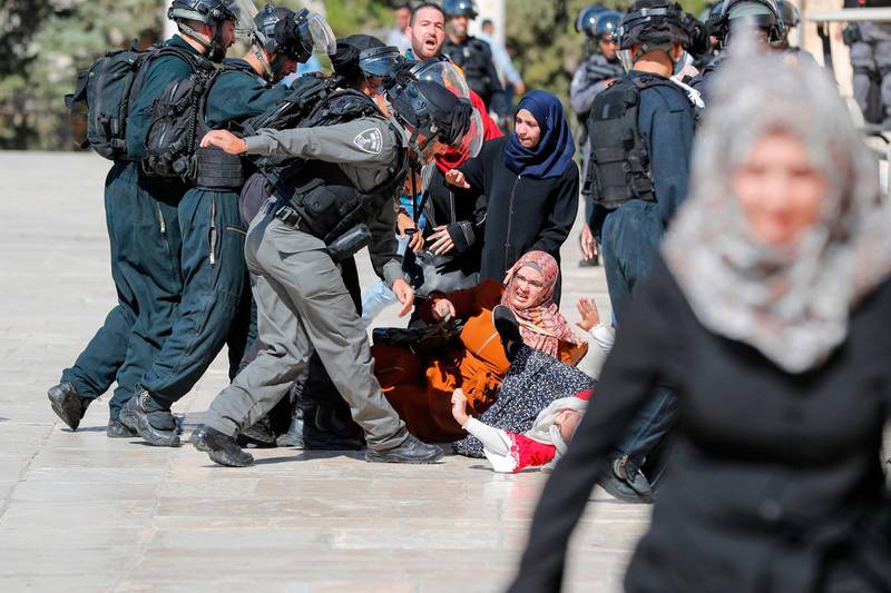 Israeli security forces scuffle with Palestinians at the Al Aqsa Mosque compound. AFP