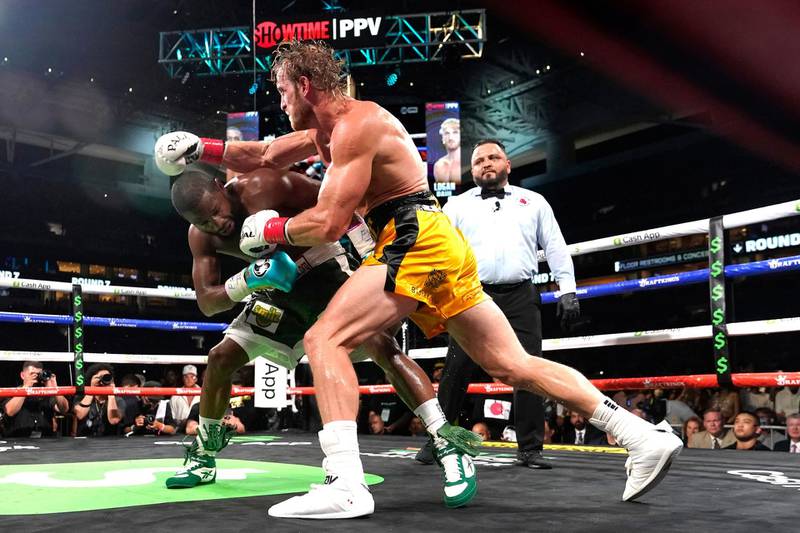 Floyd Mayweather evades a punch from Logan Paul during an exhibition fight at Hard Rock Stadium. AP