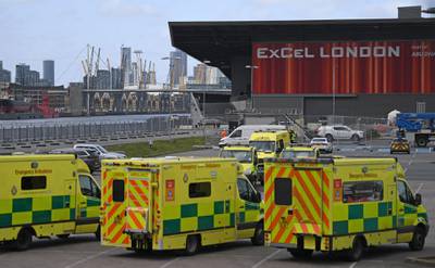 London Ambulances are pictured parked in the car park at the ExCeL London exhibition centre in London on March 29, 2020, which has been transformed into a field hospital to be known as the NHS Nightingale Hospital, to help with the novel coronavirus COVID-19 pandemic.  Prime Minister Boris Johnson warned Saturday the coronavirus outbreak will get worse before it gets better, as the number of deaths in Britain rose 260 in one day to over 1,000. The Conservative leader, who himself tested positive for COVID-19 this week, issued the warning in a leaflet being sent to all UK households explaining how their actions can help limit the spread. "We know things will get worse before they get better," Johnson wrote. / AFP / DANIEL LEAL-OLIVAS
