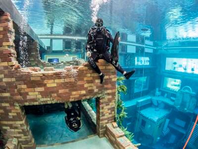 Divers are able to explore an underwater world, complete with an abandoned streetscape, apartment, garage, arcade and other interesting features.