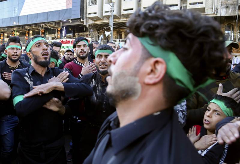 Shiite pilgrims in Baghdad beat themselves as a sign of grief outside the golden-domed shrine of Imam Moussa Al Kadhim, who died at the end of the eight century. AP