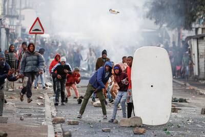 Missiles are hurled at police as taxi drivers protest over traffic regulations in Cape Town, South Africa. Reuters