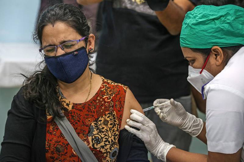 A woman is vaccinated against Covid-19 at Rajawadi Hospital in Mumbai, India. EPA