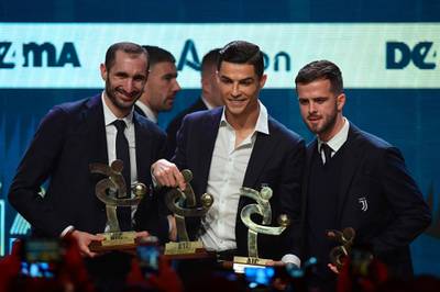 Giorgio Chiellini, Cristiano Ronaldo and Miralem Pjanic on stage together after being named in the Gran Gala del Calcio 2019 Best XI. AFP