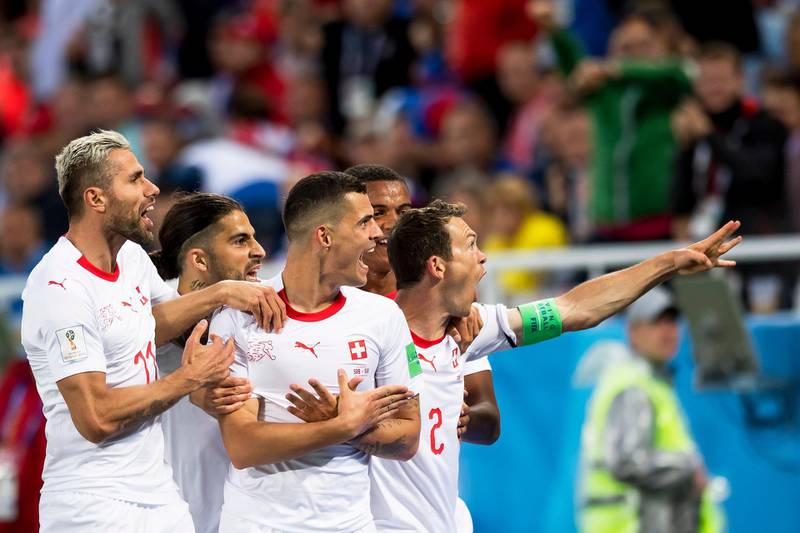 epa06831890 Switzerland's midfielder Granit Xhaka (C) celebrates with his teammates after scoring the 1-1 equalizer during the FIFA World Cup 2018 group E preliminary round soccer match between Switzerland and Serbia in Kaliningrad, Russia, 22 June 2018. 

(RESTRICTIONS APPLY: Editorial Use Only, not used in association with any commercial entity - Images must not be used in any form of alert service or push service of any kind including via mobile alert services, downloads to mobile devices or MMS messaging - Images must appear as still images and must not emulate match action video footage - No alteration is made to, and no text or image is superimposed over, any published image which: (a) intentionally obscures or removes a sponsor identification image; or (b) adds or overlays the commercial identification of any third party which is not officially associated with the FIFA World Cup)  EPA/LAURENT GILLIERON   EDITORIAL USE ONLY