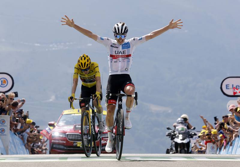 UAE Team Emirates rider Tadej Pogacar celebrates as he crosses the finish line to win Stage 17 of the 2022 Tour de France on Wednesday, July 20. Reuters