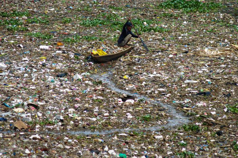 A man collects plastic from the polluted Citarum river in West Bandung, Indonesia. AFP