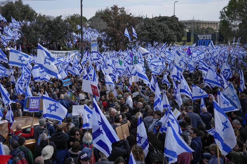 Israelis wave national flags at the rally in Jerusalem. AP