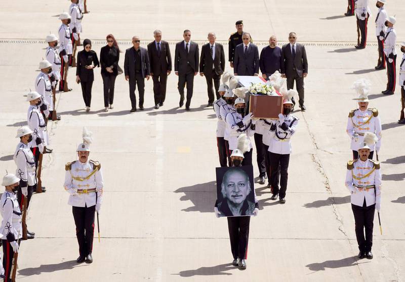 Iraq’s Prime Minister Mustafa Al Kadhimi and other officials walk behind the coffin of Iraqi poet Muthaffar Al Nawab after its arrival at Baghdad airport. Photo: Iraq PMO Twitter