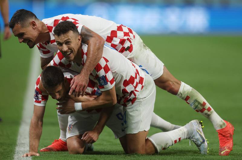 Croatia's Andrej Kramaric celebrates scoring their third goal with teammates Ivan Perisic and Dejan Lovren. Reuters