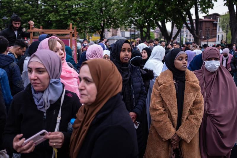 Women wait to take part in prayers at the mosque. Getty