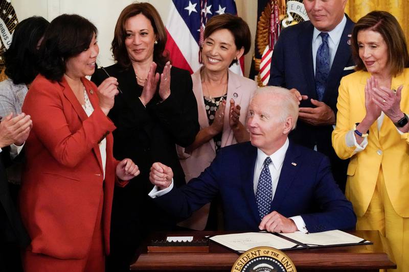 US President Joe Biden receives a pen from Representative Grace Meng next to Vice President Kamala Harris and Speaker of the House Nancy Pelosi at the signing ceremony of HR 3525, the 'Commission To Study the Potential Creation of a National Museum of Asian-Pacific American History and Culture Act' at the White House. Reuters