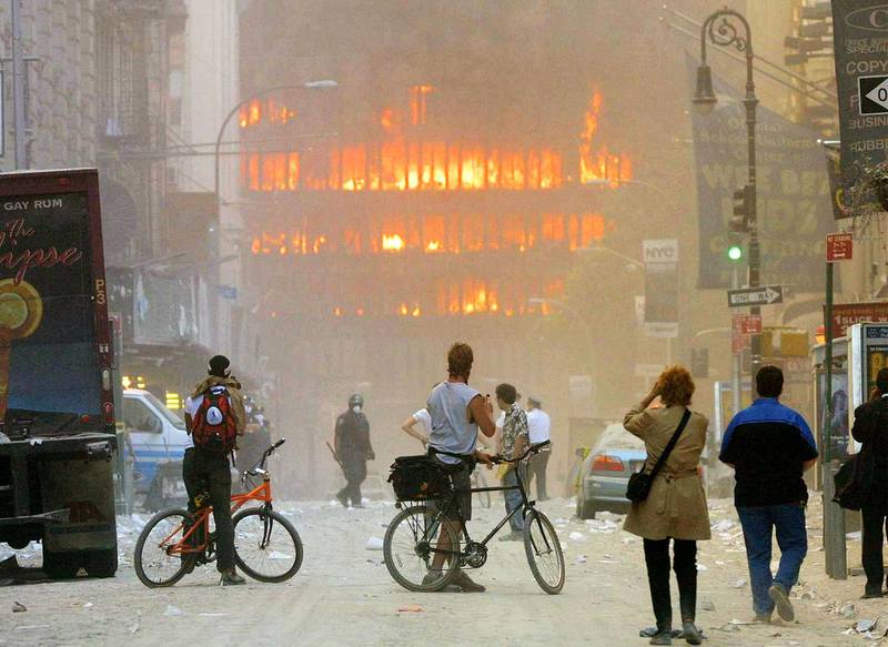 394261 111: People walk in the street in the area where the World Trade Center buildings collapsed September 11, 2001 after two airplanes slammed into the twin towers in a suspected terrorist attack.   Mario Tama/Getty Images/AFP