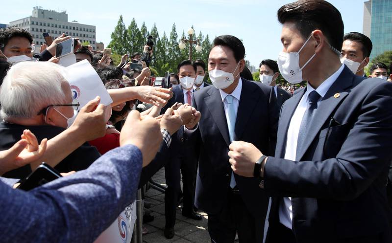 Incoming President Yoon Suk-yeol is greeted by his supporters as he arrives for his inauguration ceremony at the National Assembly in Seoul, South Korea. Reuters
