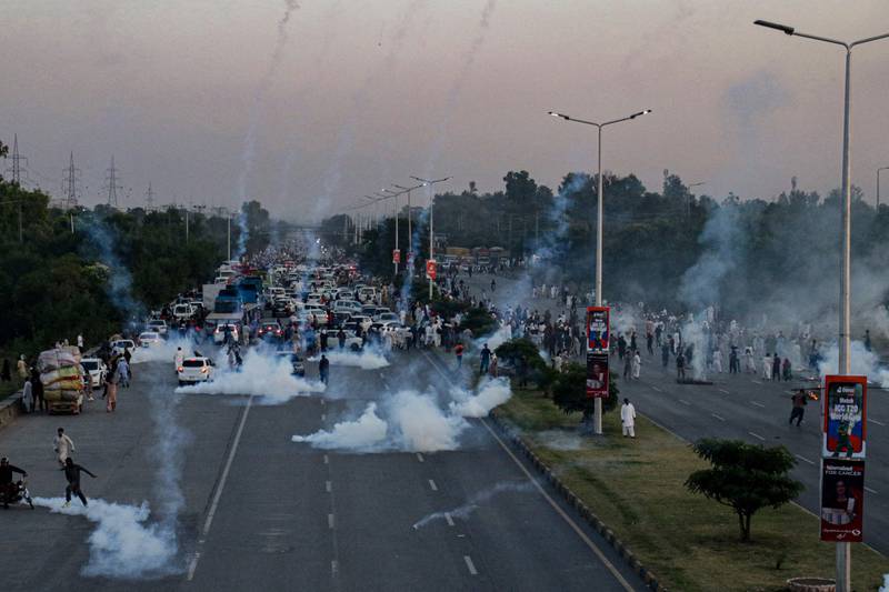 Police use tear gas to disperse PTI protesters, in the capital Islamabad. AFP