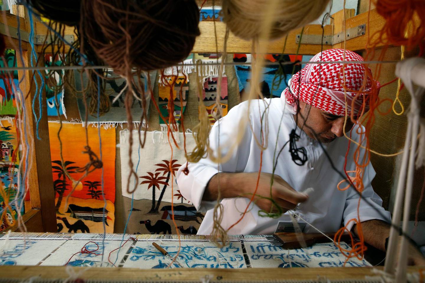 ABU DHABI - UNITED ARAB EMIRATES - 08MAY2017 - Amer Eid Ahmed who demonstrates his carpet weaving skills to tourist at Emirates Heritage village at the breakwaters in Abu Dhabi. Ravindranath K / The National (Standalone for News) *** Local Caption ***  RK0805-WEAVING05.jpg