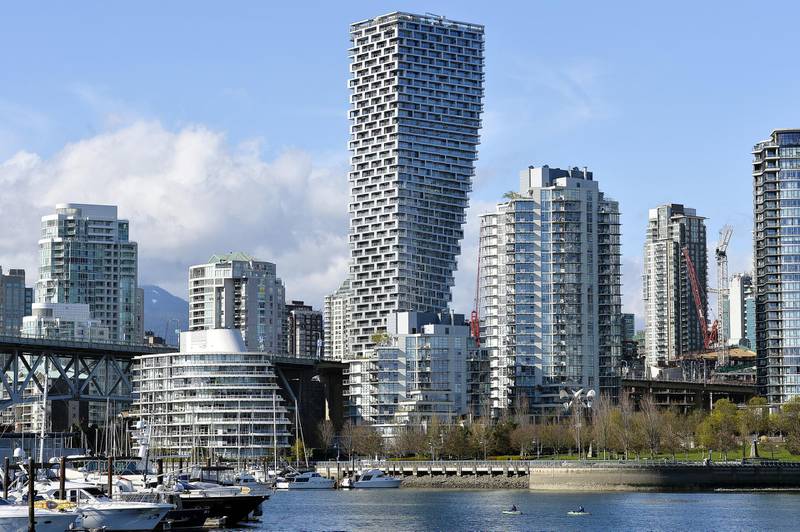 Kayakers paddles past the Vancouver House building under construction in Vancouver, British Columbia, Canada, on Monday, April 8, 2019. Government policies to tame the housing market -- from new taxes to stricter mortgage regulations -- have fueled a plunge in sales to the weakest since the global financial crisis. Prices are down 8.5 percent from their peak in June, according to the Real Estate Board of Greater Vancouver. Photographer: Jennifer Gauthier/Bloomberg