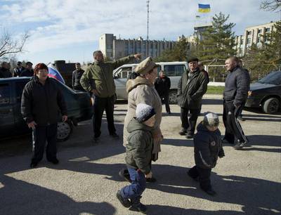 Local residents, some of them pro-Russian supporters, gather outside the Ukrainian naval base headquarters in Novo-Ozerne, Ukraine, on Monday March 3, 2014. Ivan Sekretarev / AP photo