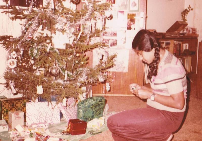 Christmas at the John Jacobs house, Sharjah, 1976 to 1983. Seen here is the family's nanny, Pathma, beside the tree. Photo: Truus Jacobs